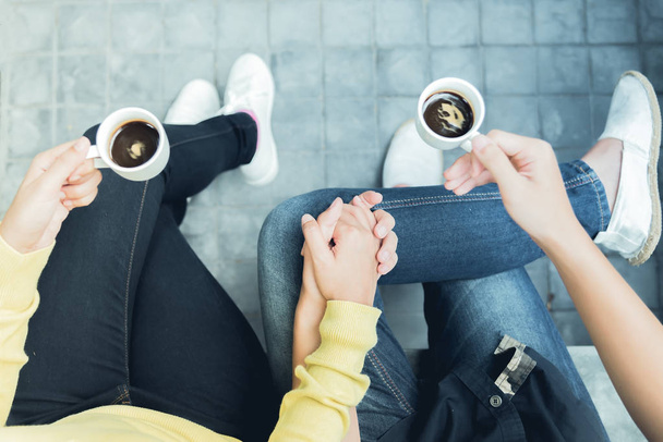 Couple enjoying coffee .Overhead of a couple sitting close with coffee - Photo, Image