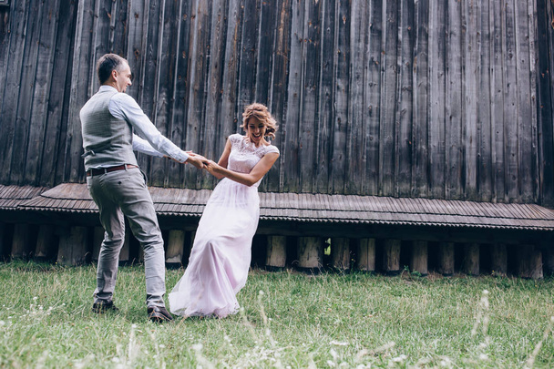 Newlyweds dance and have fun outdoors. - Φωτογραφία, εικόνα
