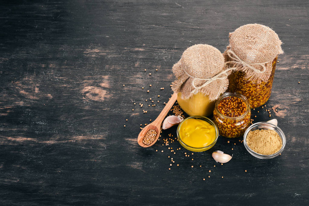 A set of mustard and spice. On a wooden background. Top view. Copy space for your text. - Fotoğraf, Görsel