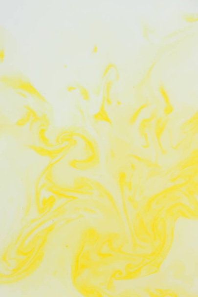Abstract yellow background, pastel pattern, yellow paint in white liquid, stains on milk, art, minimalistic background, blank for designer, pop art, creative layout - Φωτογραφία, εικόνα