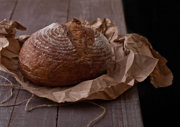 Freshly baked  bread with on brown oven paper - Photo, Image