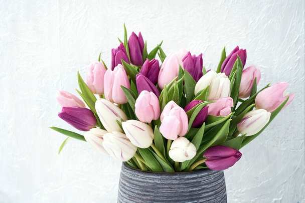 White and pink tulips in vase. Holiday background, copy space - Photo, Image