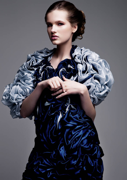 Beautiful fashion model wearing blue silk dress  - Valokuva, kuva