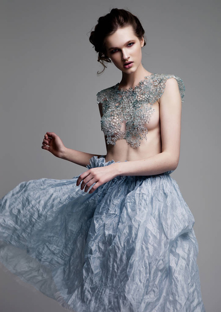 Beautiful fashion model wearing glass bra and skirt - Foto, Imagem