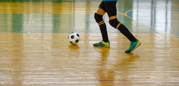 Children teen training soccer futsal indoor gym. Young boy with soccer ball training indoor football. - Photo, Image