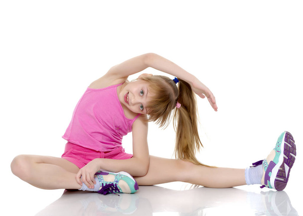 The gymnast perform an acrobatic element on the floor. - Valokuva, kuva