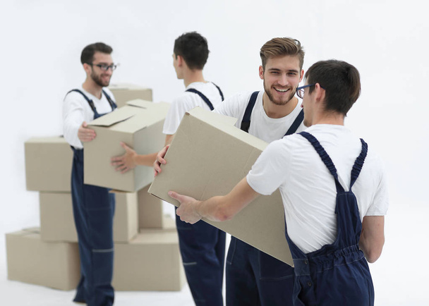 Portrait of movers holding box smiling isolated on white backgro - 写真・画像