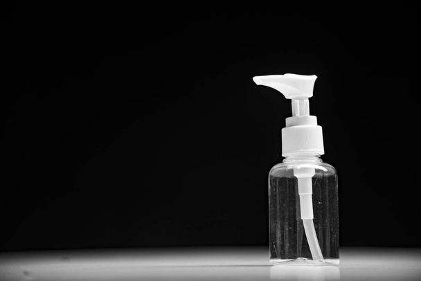 Empty cosmetic bottle container isolated on black background - Valokuva, kuva