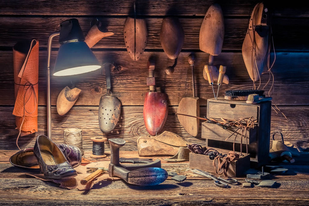 Vintage shoemaker workplace with brush, shoes and shoelaces - Φωτογραφία, εικόνα