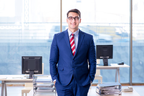 Young handsome businessman employee working in office at desk - Foto, imagen
