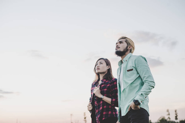 Loving hipster couple standing against clear sky. Couple relaxin - Photo, Image