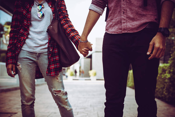 Close up of hipster couple in love hand in hand walking through  - Foto, Imagem
