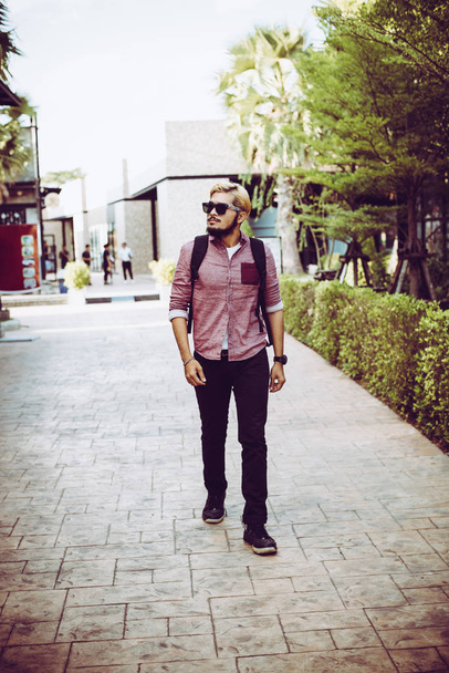 Portrait of handsome hipster man in jeans clothes and sun glasse - Foto, Imagem