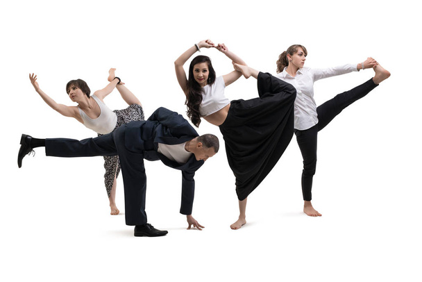 A man and women in office clothes doing yoga - Foto, Bild