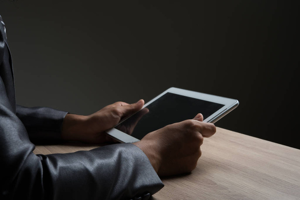 Businessman holding tablet and looking on a blank screen. - Foto, Imagem