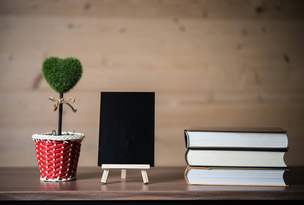 Composition with Small Chalkboard and Stack of Books. - 写真・画像