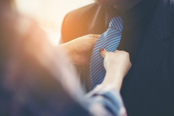Businessmen are tying neckties to the boss. - Photo, Image