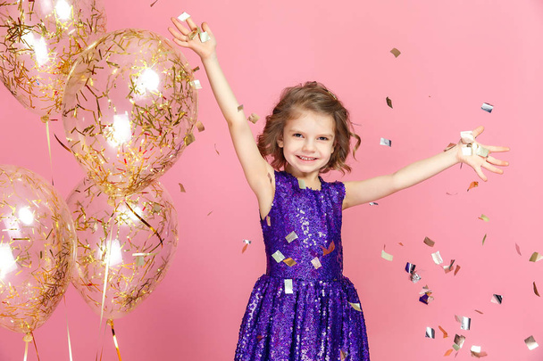 Happy girl in pink dress celebrating - Valokuva, kuva