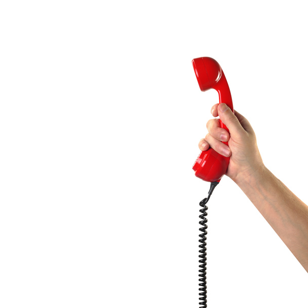 Obiektów ręce akcji - ręka trzyma telefon retro czerwona słuchawka. Isola - Zdjęcie, obraz