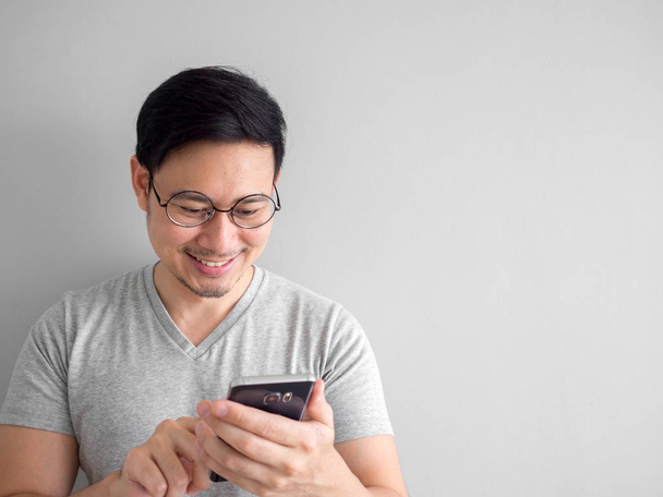 Happy man is using smartphone. Concept of using social media on  - Foto, Bild