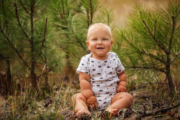 Portrait of a baby boy in green pine forest - Foto, Imagem