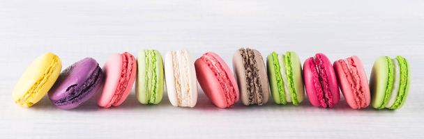long horizontal row of colorful bright biscuits on white background - Фото, зображення