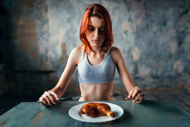 unhappy skinny woman against plate with food, absence of appetite, weight loss, anorexia - Photo, Image