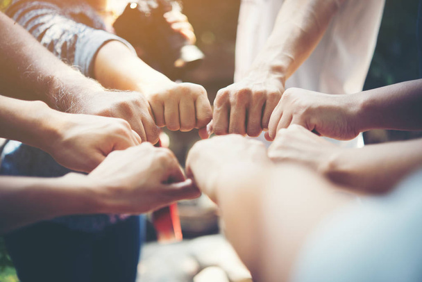 Close up of young people putting their hands together. Team with stack of hands showing unity and teamwork. - Foto, Imagem