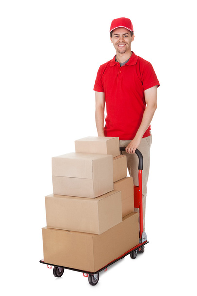 Deliveryman with a trolley of boxes - Фото, изображение