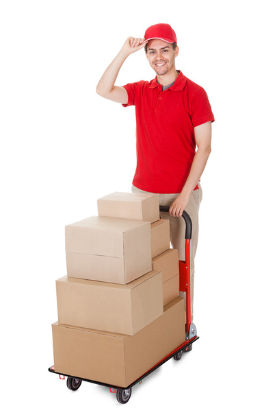 Deliveryman with a trolley of boxes - Foto, Imagen