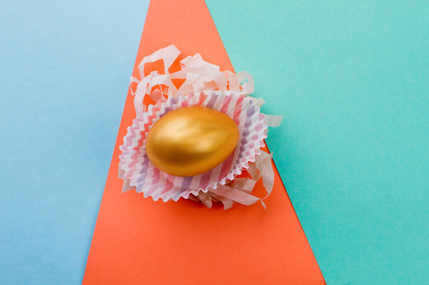 Golden egg on colorful background. - Фото, изображение