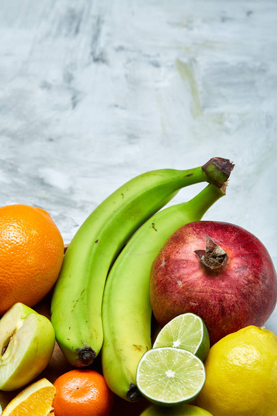 Спелые свежие фрукты в деревянной пластине на светлом фоне, избирательный фокус, крупный план, вид сверху
 - Фото, изображение