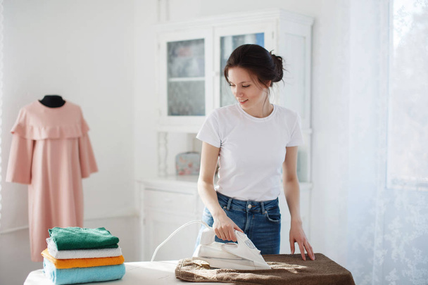 A pretty girl ironing clothes - Photo, Image