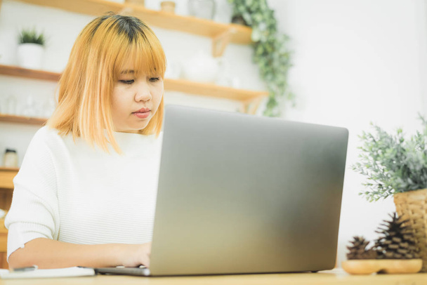 Laptop evde iken ofis çalışma alanı çalışma güzel genç gülümseyen Asyalı kadın. Taşınabilir bilgisayar klavyede yazma yoluyla evden çalışma iş kadını. Evde zaman zevk. - Fotoğraf, Görsel