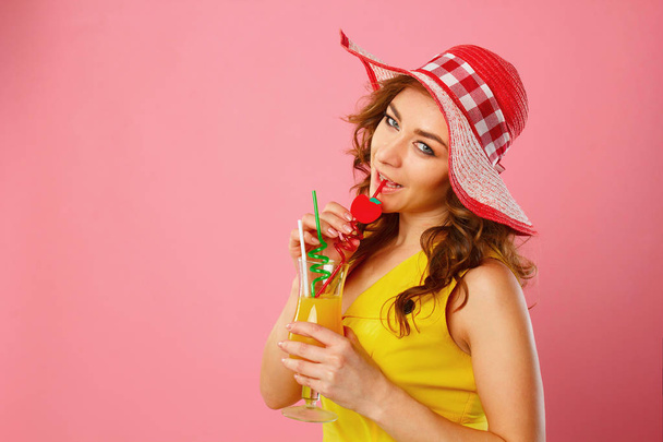 Portrait of young beautiful blond woman in red hat with drinking - Photo, image