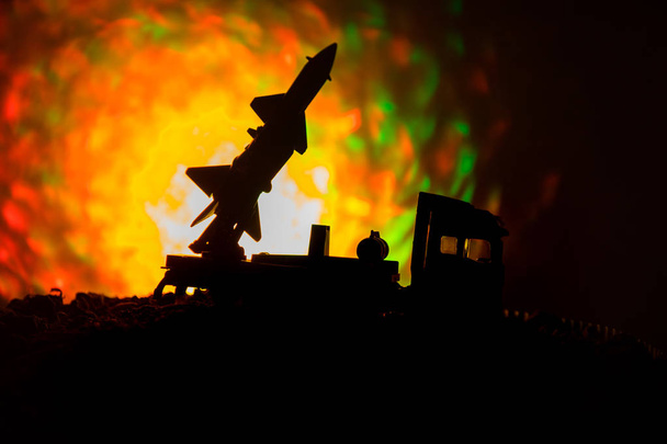 Rocket launch with fire clouds. Battle scene with rocket Missiles with Warhead Aimed at Gloomy Sky at night. Rocket vehicle on War Backgound. - Photo, Image