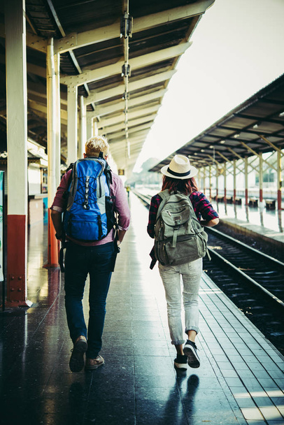 Couple holiday concept : Young hipster couple in train station. - Photo, Image