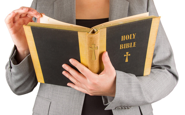 Woman in business suit is reading a holy bible - Fotografie, Obrázek