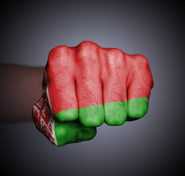 Front view of punching fist on gray background - Photo, Image