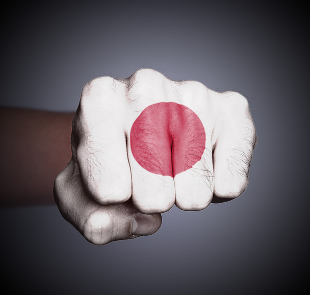 Front view of punching fist on gray background - Photo, Image