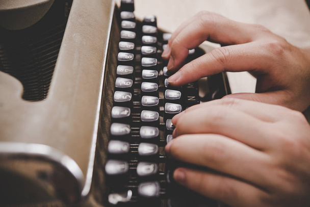 Mãos digitando na máquina de escrever vintage na mesa de madeira
. - Foto, Imagem