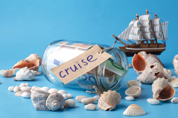 Vacation concepr on blue with ship and shell - 写真・画像