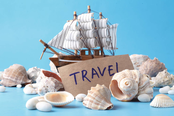 Sea travel in vacation concet with shell and ship - Foto, afbeelding