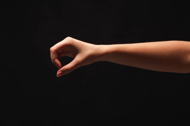 Ženská ruka něco, výřez na černé - Fotografie, Obrázek