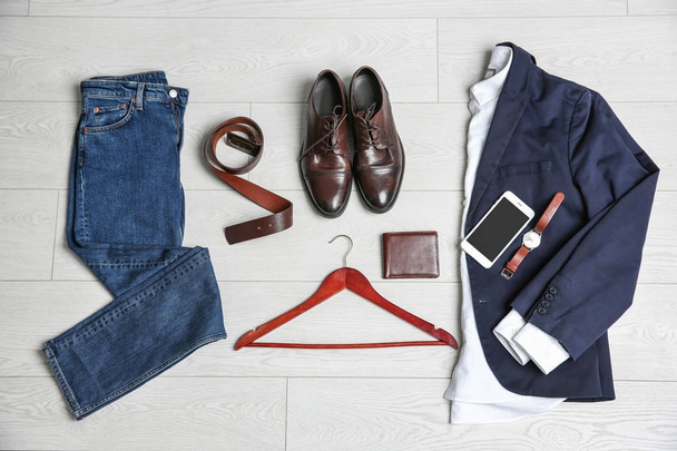 Male clothes, footwear and accessories on wooden background - Fotó, kép