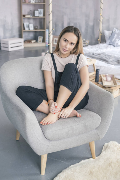 Stylish caucasian woman in casual hipster outfit sitting on a so - Фото, изображение