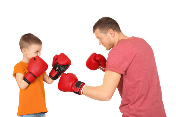 Happy dad and his son boxing on white background. Father's day celebration - Foto, afbeelding