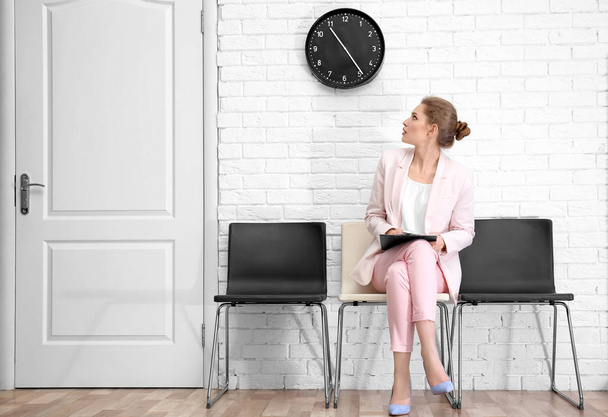 Young woman waiting for job interview, indoors - Foto, Bild