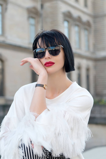 Woman in sunglasses posing on building in Paris, France. - Photo, Image