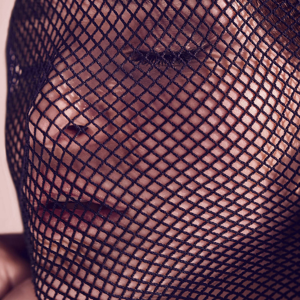 Beautiful sensual woman in a black veil on her face. - Foto, afbeelding